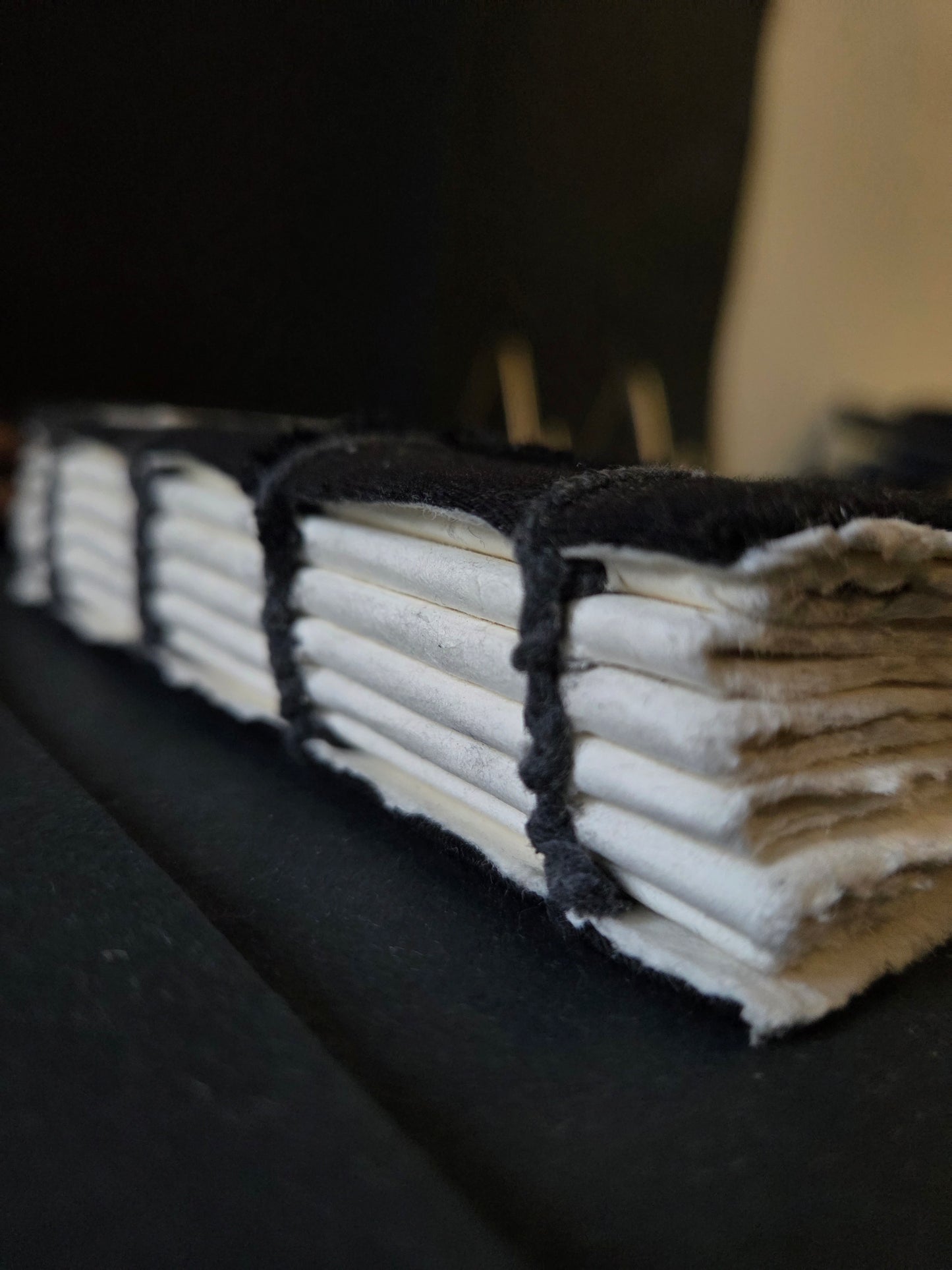 This is an open spine journal where the stitch is visible and it is coptic stitch binding with cotton thread